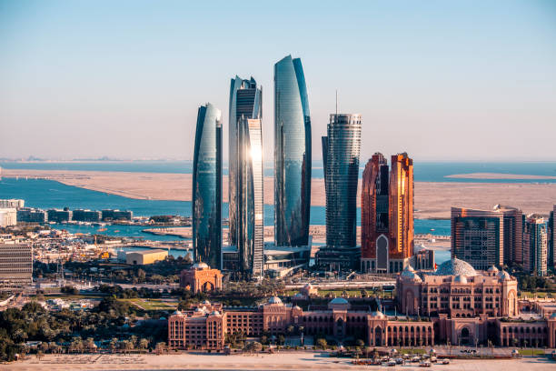 Famous Abu Dhabi skyscrapers captured from a helicopter above a downtown area.