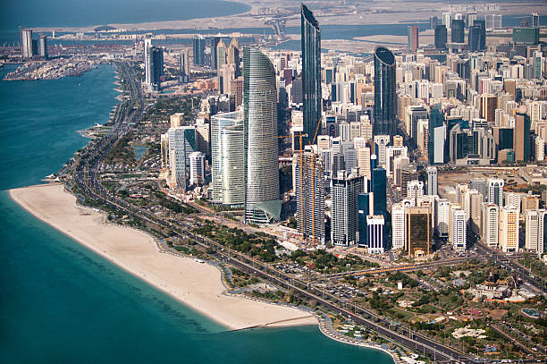 Part of Abu Dhabi, UAE with tall buildings and surrounding area viewed from the helicopter. Many details are visible in the image.