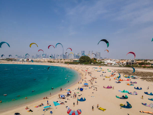 Dubai UAE, An aerial shot of Kite Beach in Dubai filled with kite surfers and their colorful kites flying in the air or being prepared on the ground